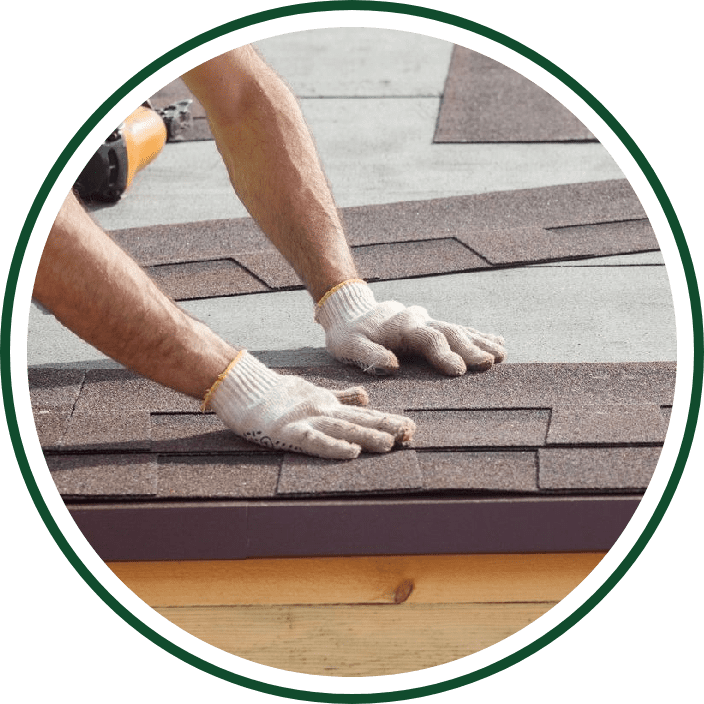 Worker installing asphalt roof shingles.