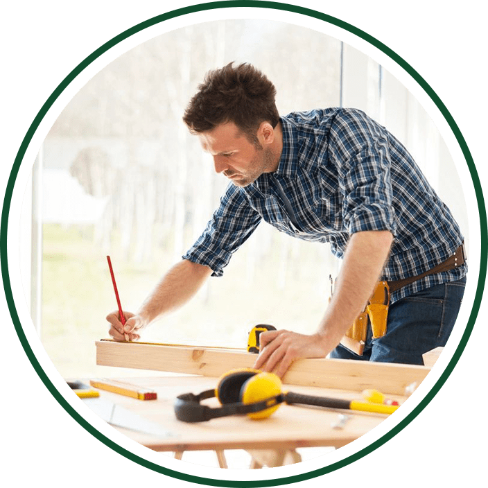 Carpenter measuring wood for project.