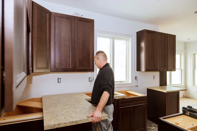 Man installing kitchen countertop.